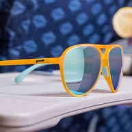 Cheesy Flight Attendant by Goodr with orange aviator frames and blue lenses, wider fit for larger heads, perfect for outdoor use