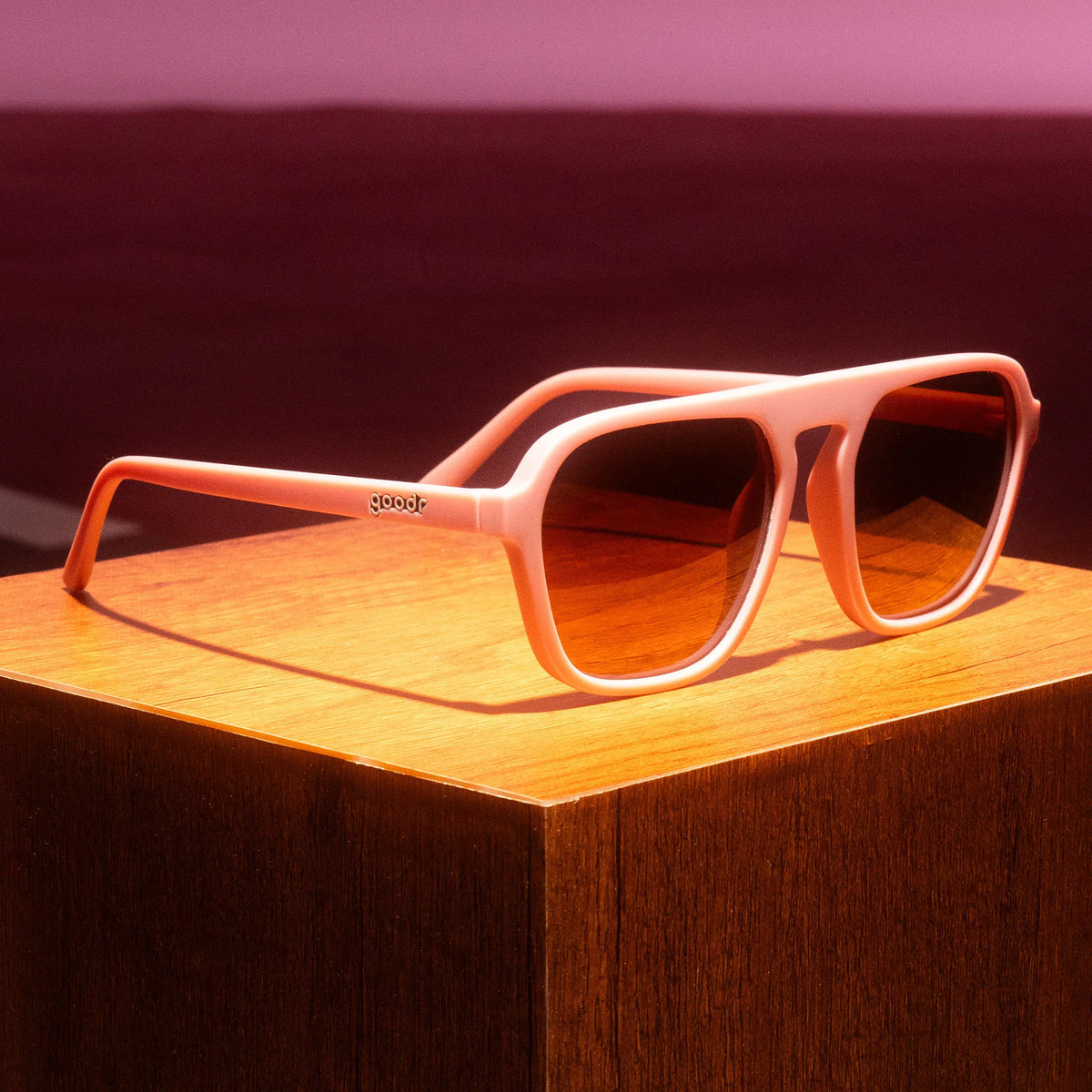 Threaten Me With a Good Time by Goodr in light pink vintage square aviator frames with brown non-reflective lenses for active outdoor use