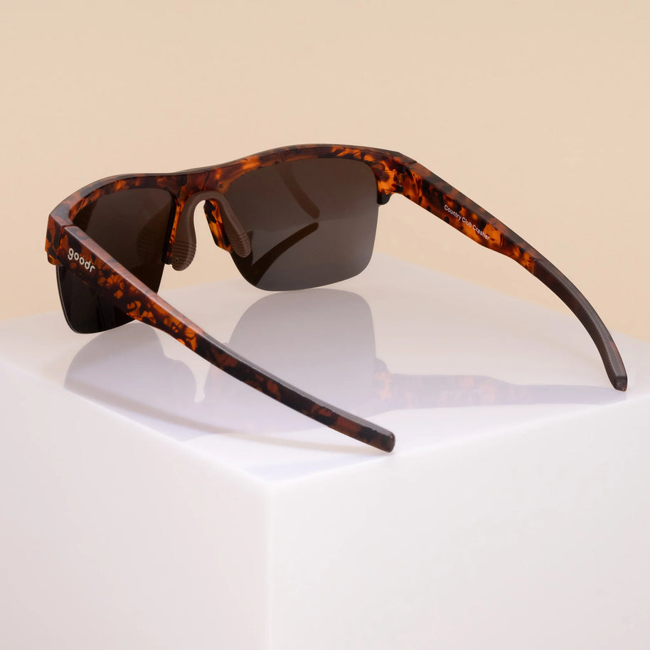 Country Club Crasher by Goodr in brown tortoiseshell with half-rim wrap frame and adjustable nose piece for stylish outdoor use