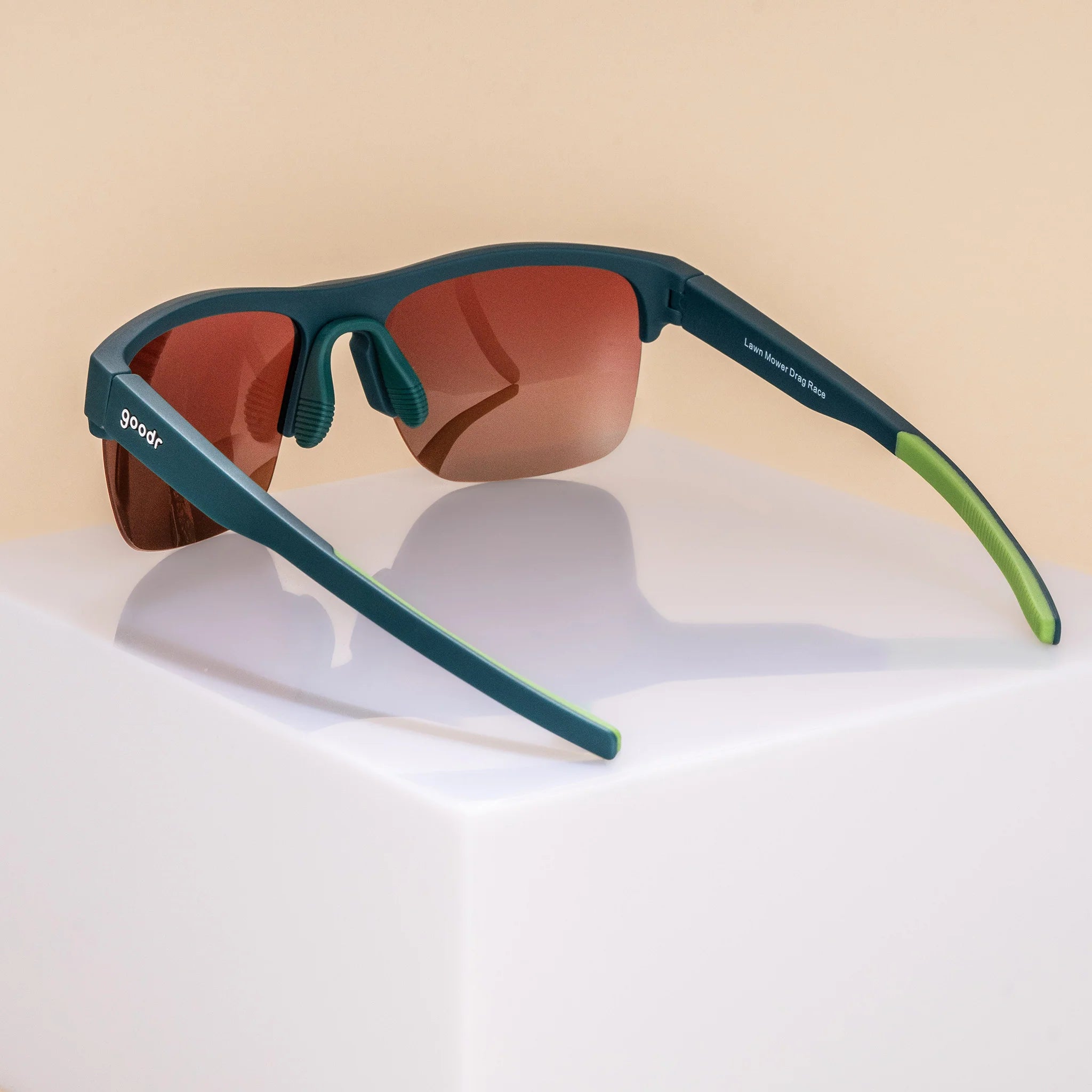 Lawn Mower Drag Race by Goodr in solid green with rose gradient lenses, adjustable nose piece, lightweight sunglasses for outdoor use