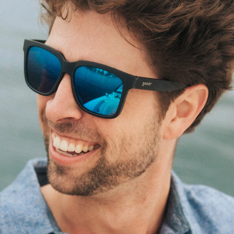 Buoys Don't Cry by Goodr, black frames with blue reflective water-repellent lenses, ideal for wave chasers and beach activities