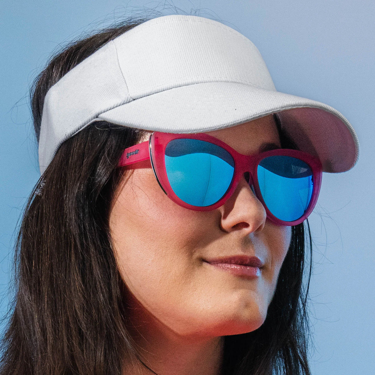 Flamingo Couture by Goodr pink translucent cat-eye sunglasses with teal reflective lenses and chrome accents for bold everyday wear