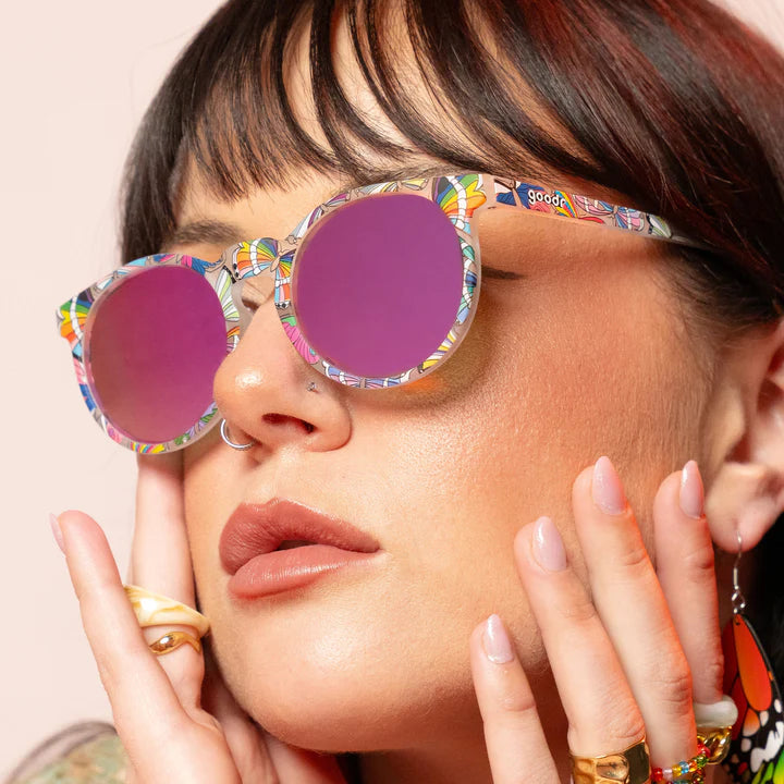 Not A Phase, A Transformation by Goodr clear glasses with purple lenses and butterfly LGBTQ+ flag design for pride and outdoor use