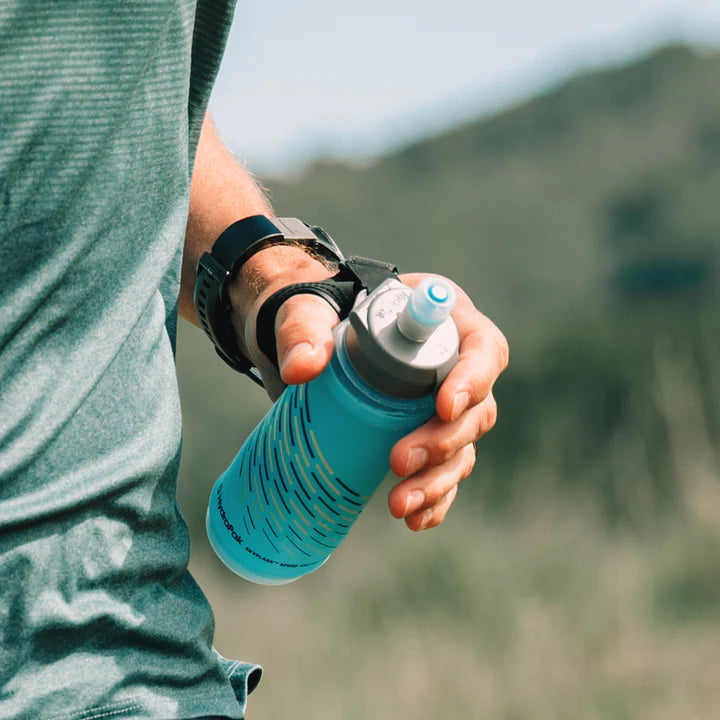 SkyFlask Speed by Hydrapak in blue, handheld running flask with thumb loop for secure grip and energy-saving hydration