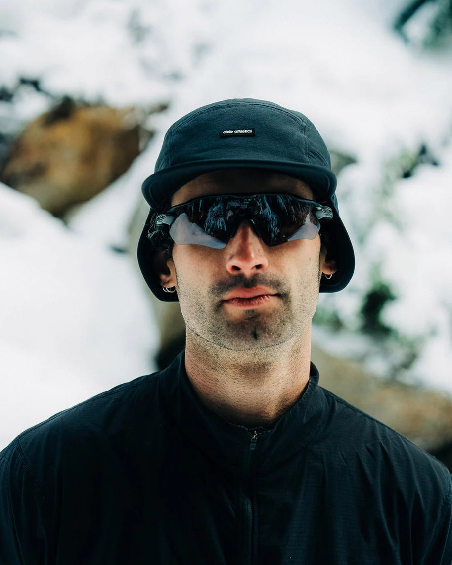 FLTCap WND - Ultra Iconic by Ciele in black with fold away ear flaps, cold weather headwear for running and outdoor use in Canada