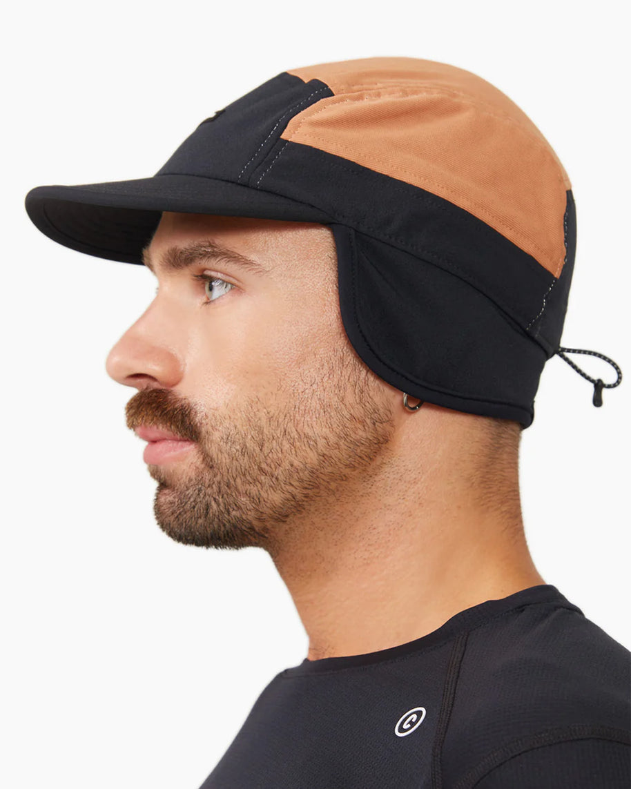 FLTCap WND - Ultra Iconic by Ciele in black and tan with fold-away ear flaps for cold weather running and outdoor protection