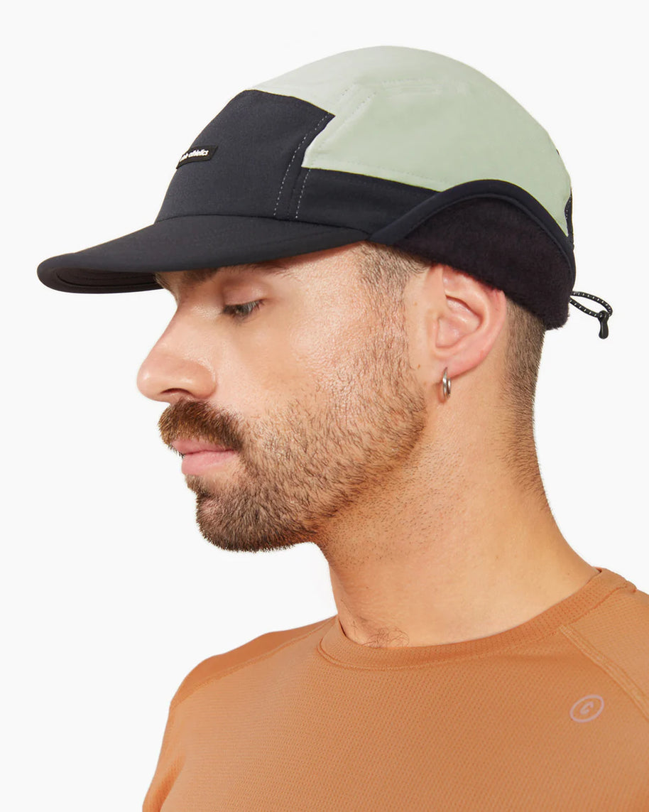 FLTCap WND - Ultra Iconic by Ciele in black and light grey, cold weather cap with fold-away ear flaps for winter running and outdoor use