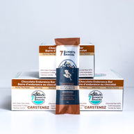 Carstensz Dark Chocolate Endurance Bar (30g) by 7 Summit Snacks, brown and white packaging, 64% Peruvian dark chocolate with honey and electrolytes for endurance energy