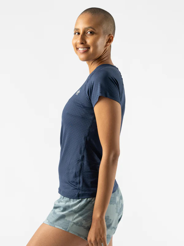 Woman wearing navy ICE Perf Tee SS - Women by Rabbit, soft, quick-dry, perforated sustainable nylon, ideal for running and active use.
