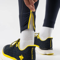 Low Light Pocket Tightz - Men by Rabbit in black with yellow accents, midweight reflective running tights with pockets for safety and warmth
