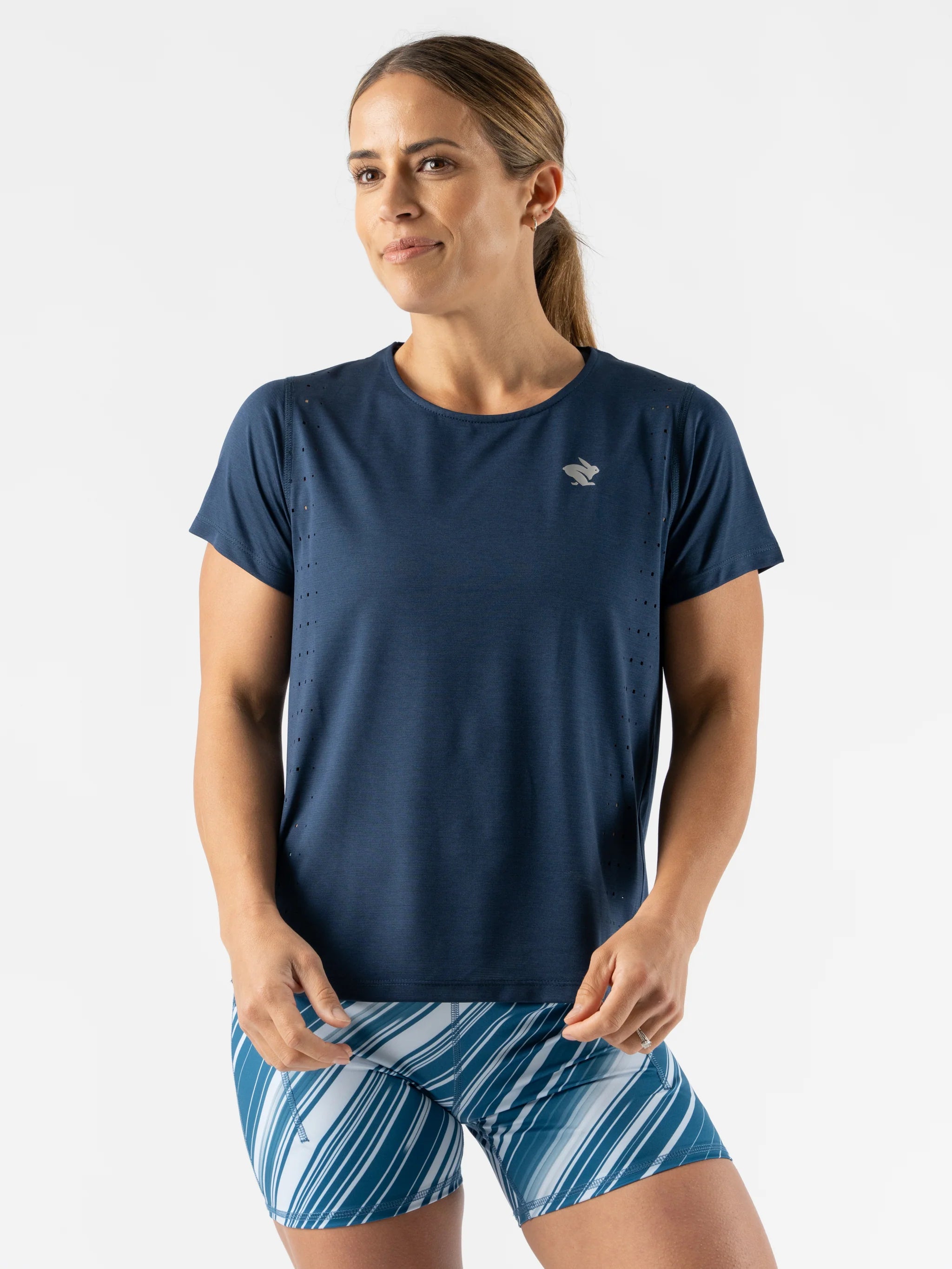 Race Pace Tee SS - Women by Rabbit in navy with laser-cut perforations, breathable semi-relaxed running shirt ideal for training and races
