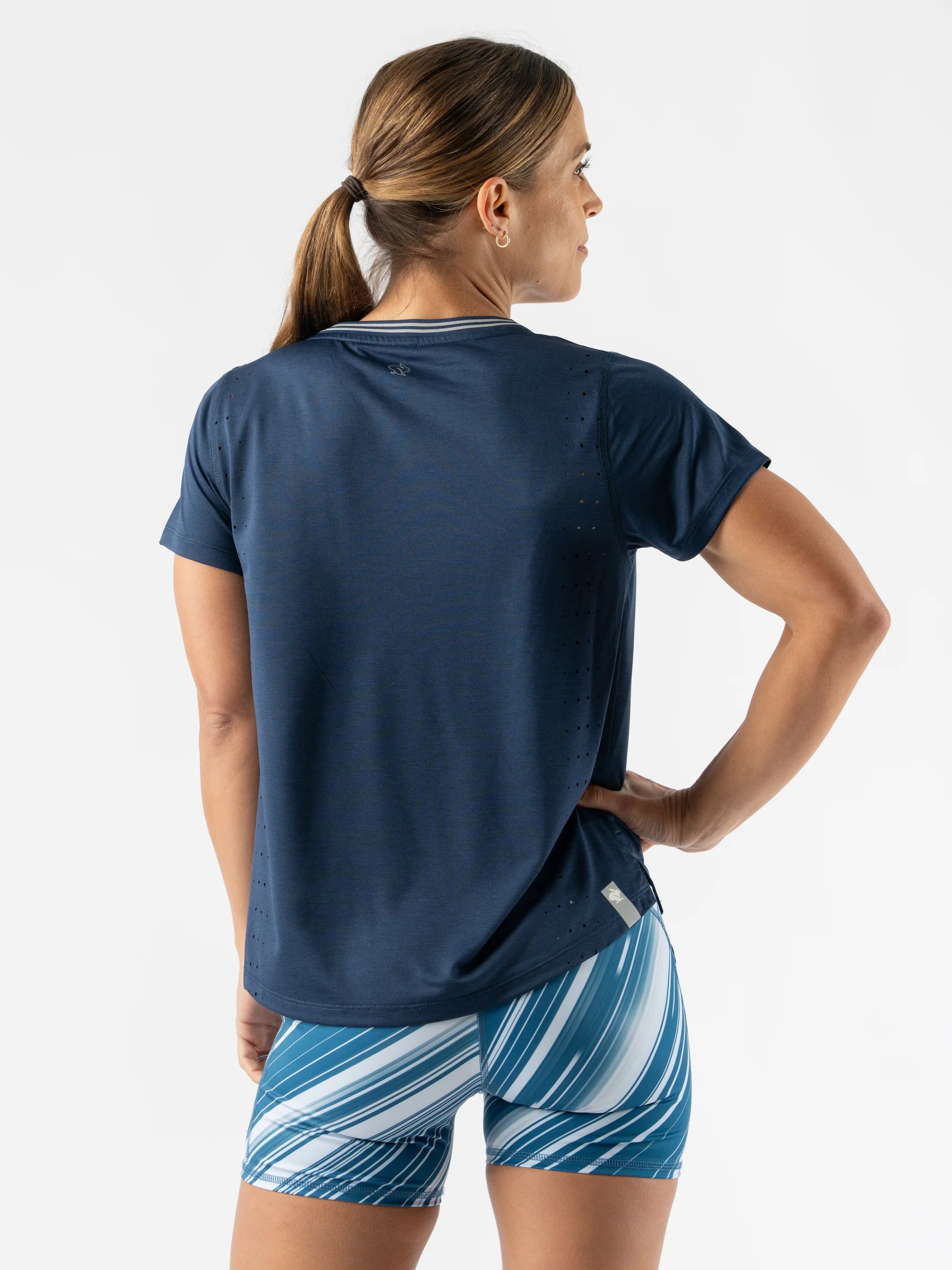 Race Pace Tee SS - Women by Rabbit in navy blue with breathable laser-cut perforations, semi-relaxed fit for running and training comfort