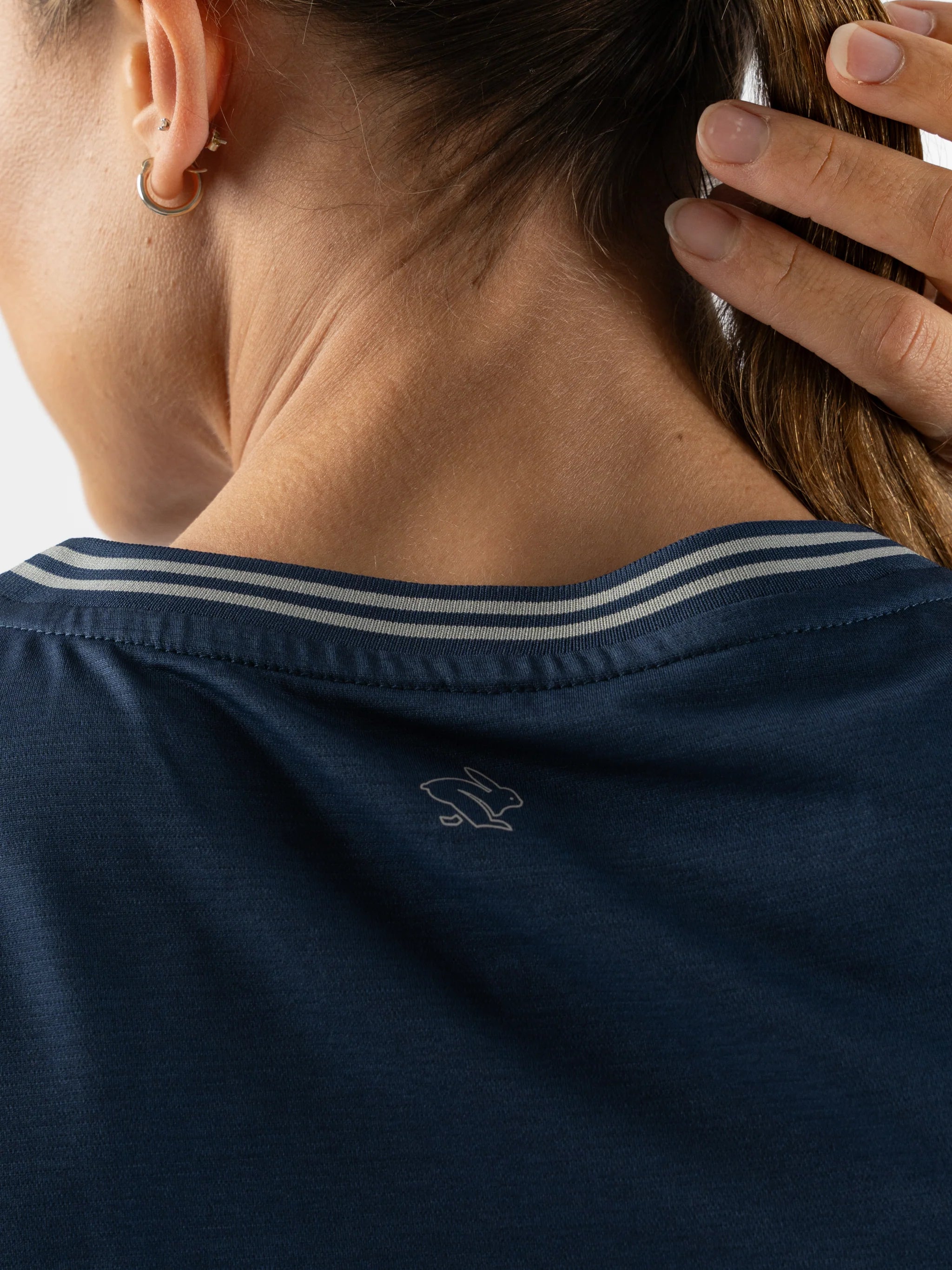 Race Pace Tee SS - Women by Rabbit in navy with breathable laser-cut perforations and micro-textured inside for running and training comfort