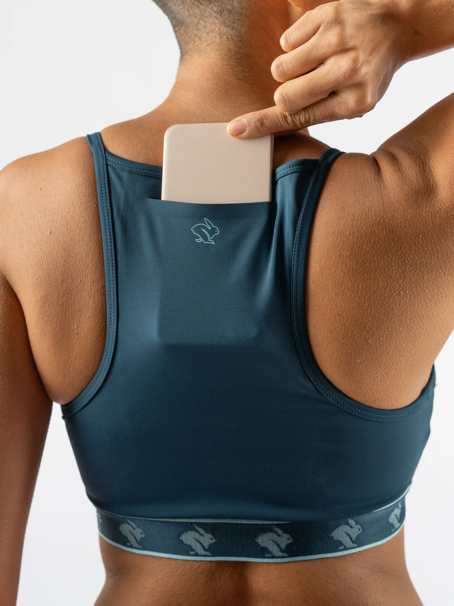 Strappy Pocket Bra - Women by Rabbit in dark teal with built-in pocket, minimal bounce, and comfort for secure storage during running and workouts