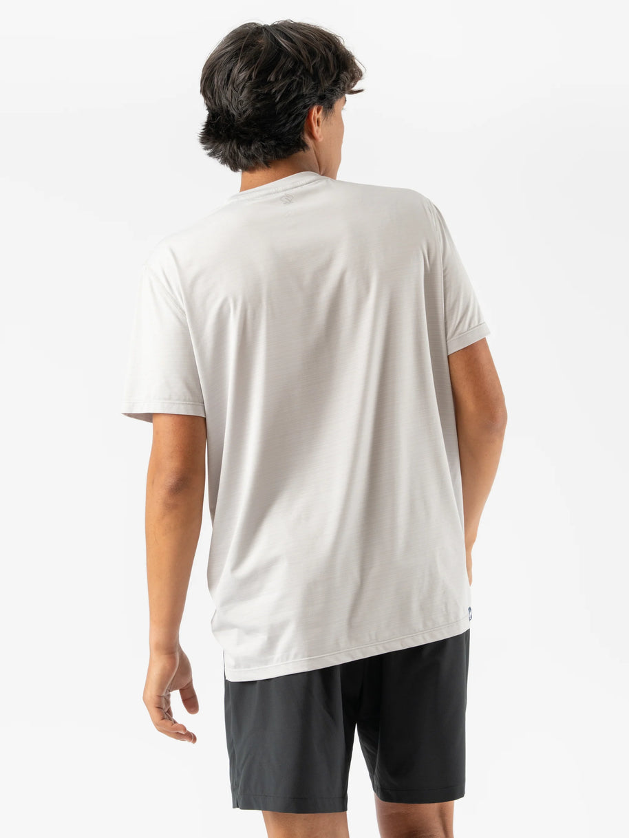 UPF Tee SS - Men by Rabbit in moonlight color, lightweight breathable shirt with UPF 50 protection and laser-cut arm vents for outdoor running.