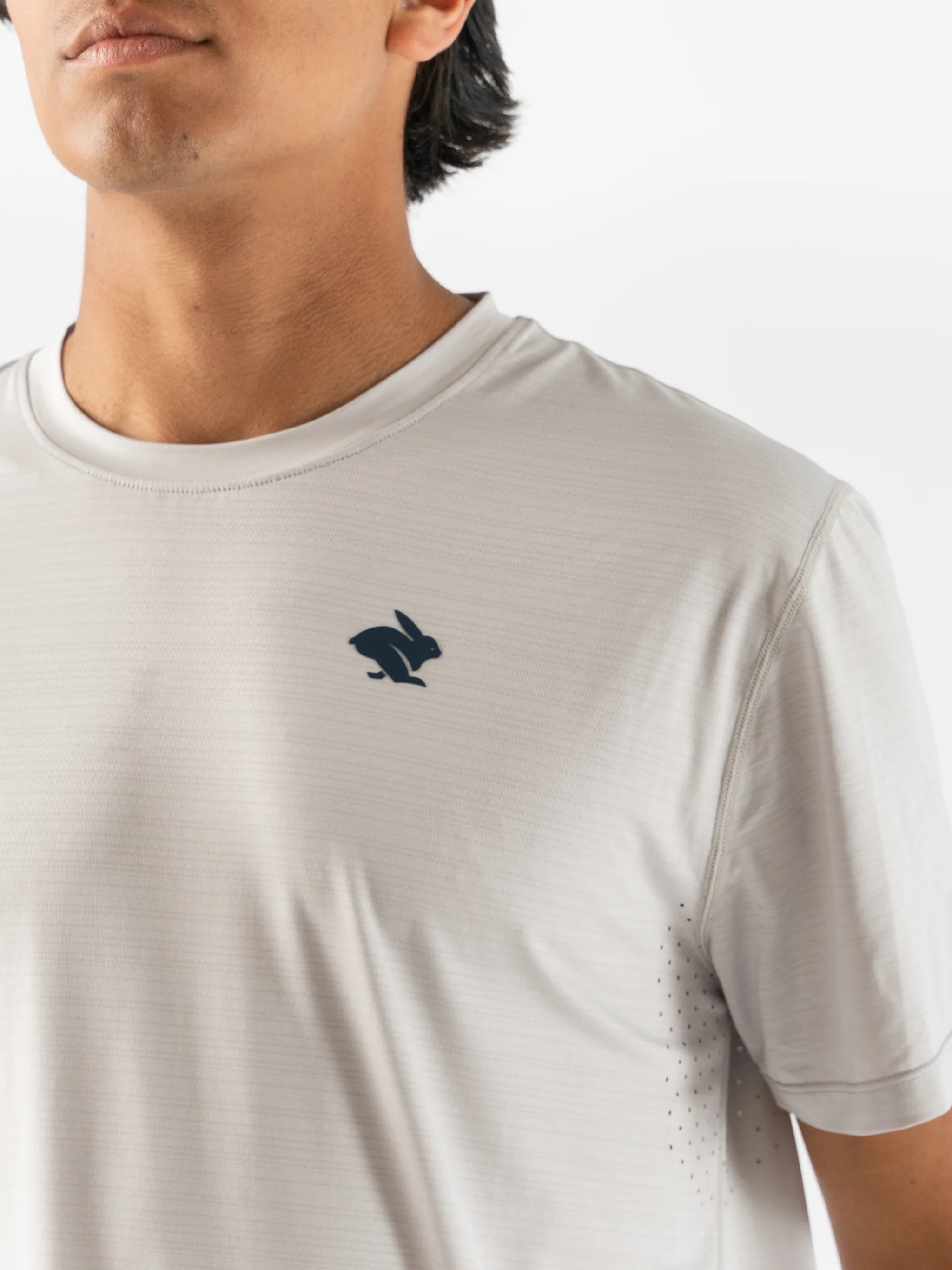 UPF Tee SS - Men by Rabbit in light grey with UPF 50 protection, lightweight breathable jersey, and laser-cut underarm vents for sun safety and running comfort