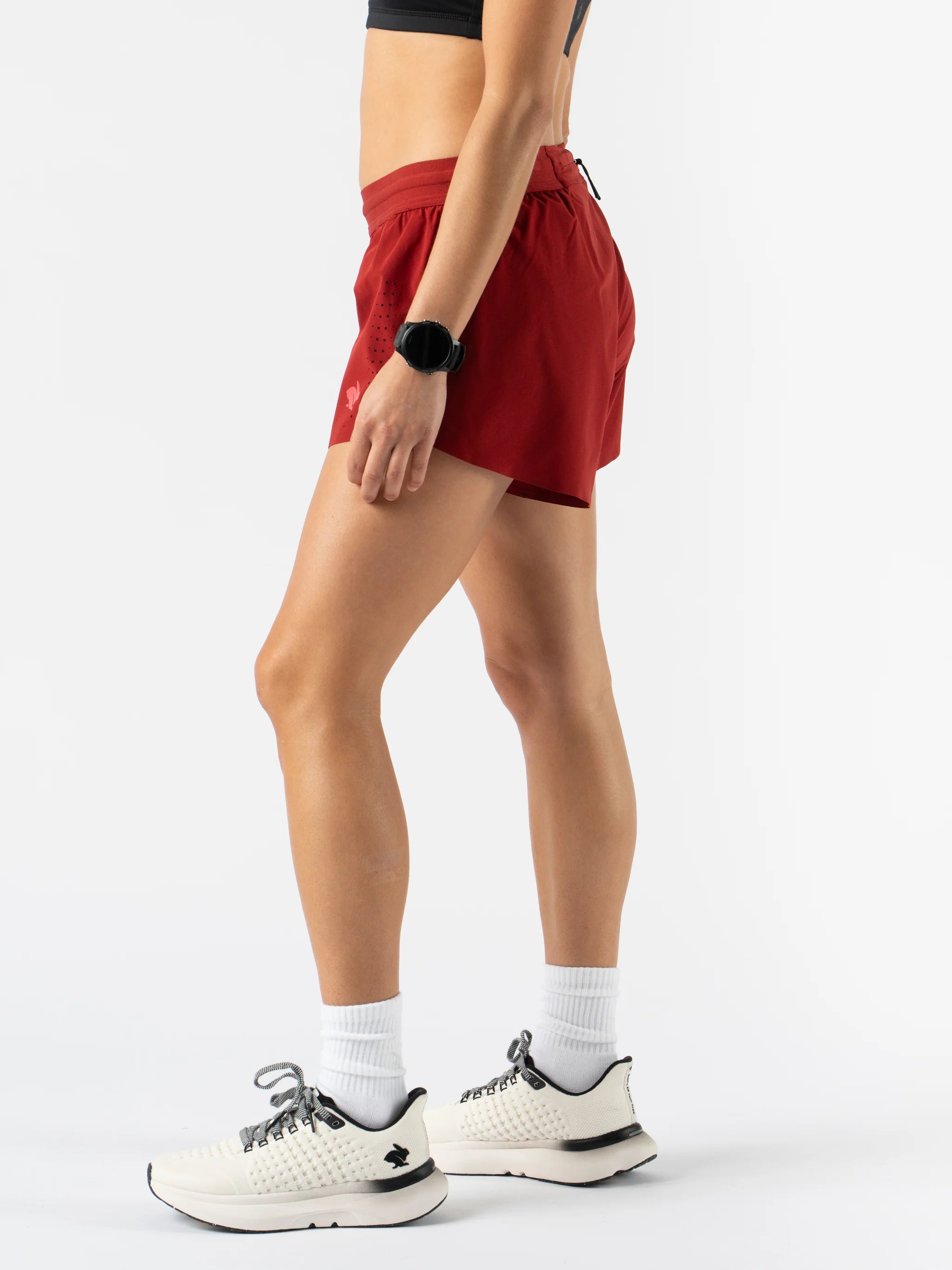 Fuel 'N Fly 4 - Women by Rabbit in red running shorts with five pockets and back zip, designed for long runs and outdoor use