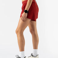 Fuel 'N Fly 4 - Women by Rabbit in red running shorts with five pockets and back zip, designed for long runs and outdoor use