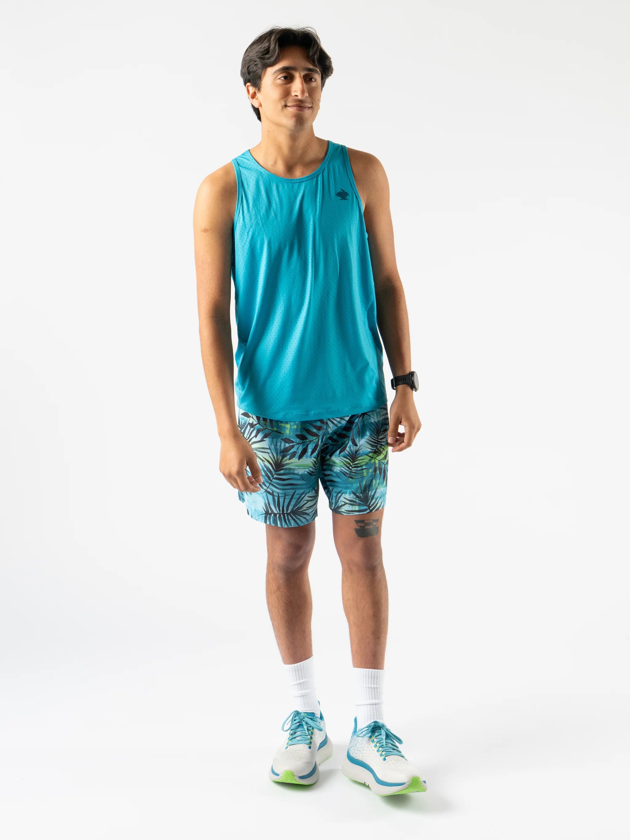 Man wearing Rabbit Ice Perf Tank - Men in blue with breathable perfs, sustainable quick-dry fabric made from recycled coffee grounds, ideal for running.