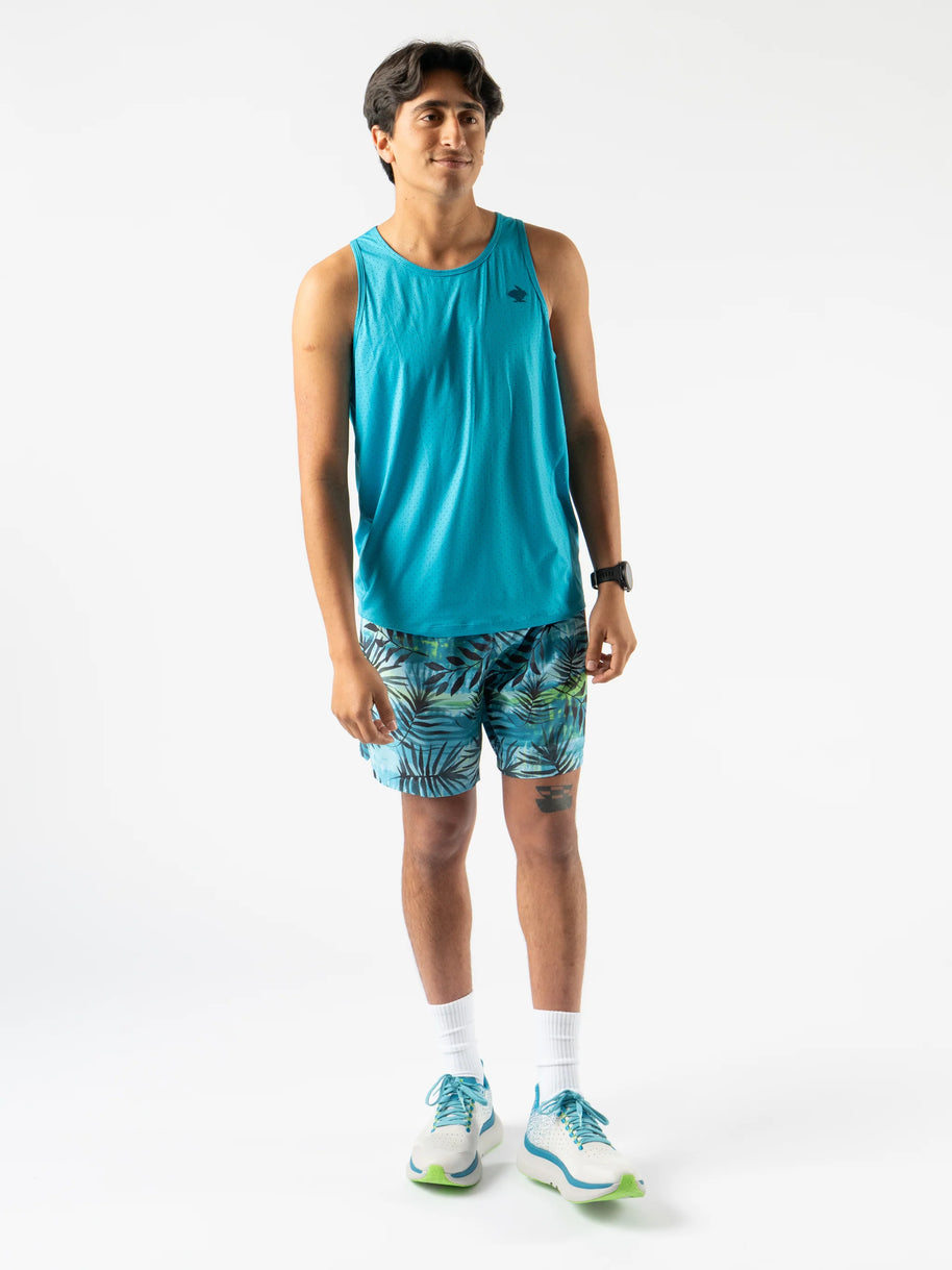 Man wearing Rabbit Ice Perf Tank - Men in blue with breathable perfs, sustainable quick-dry fabric made from recycled coffee grounds, ideal for running.