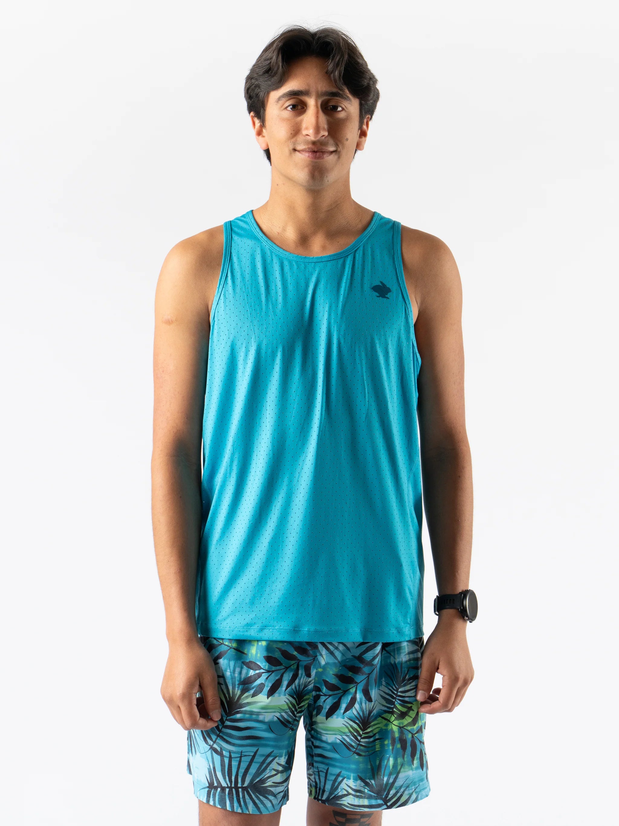 Man wearing Rabbit Ice Perf Tank - Men in blue with breathable perforations, made from recycled nylon, ideal for running and gym workouts