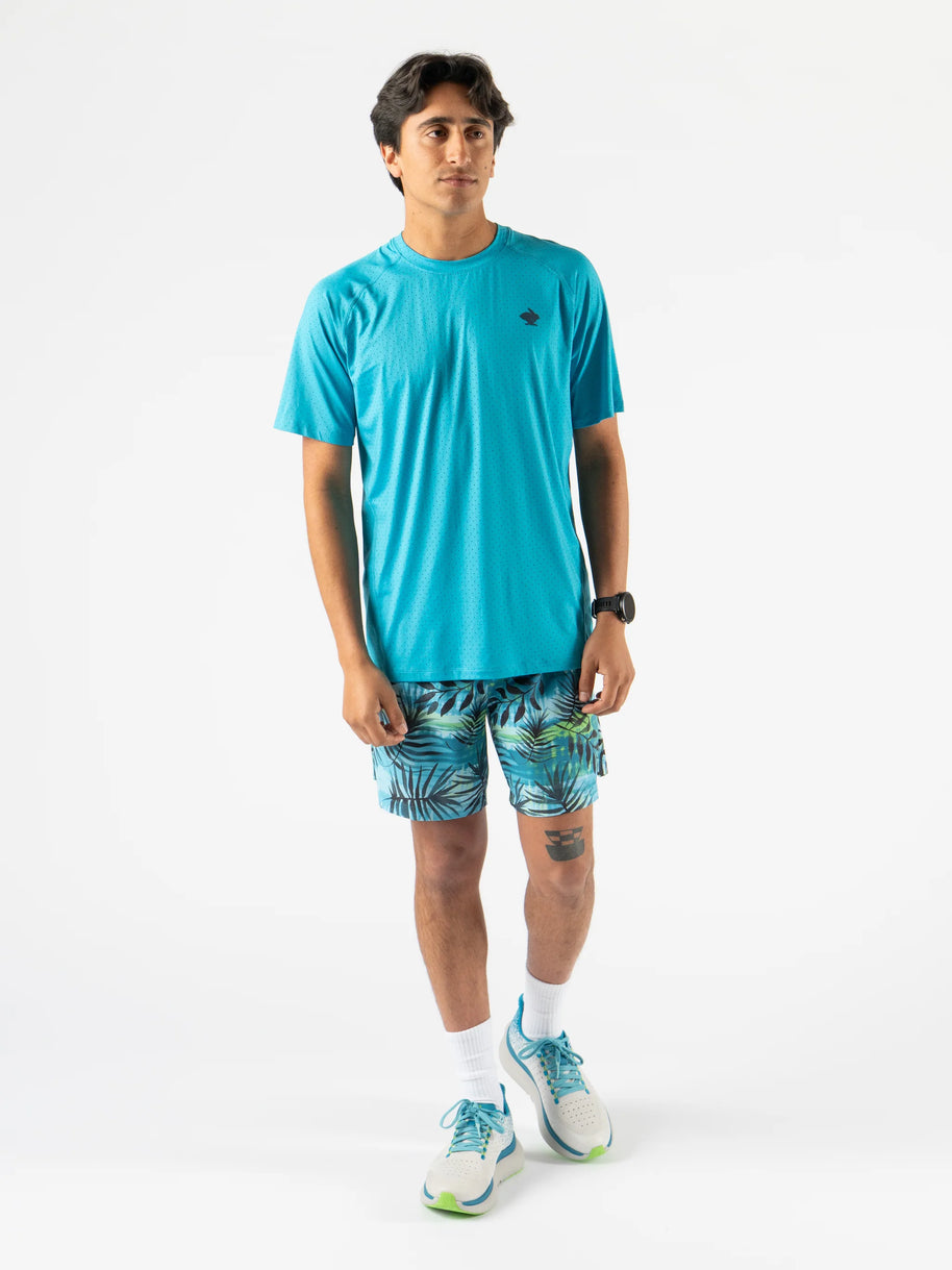 Man wearing turquoise ICE Perf Tee SS - Men by Rabbit, lightweight perforated nylon tee made from recycled coffee, quick-dry technology