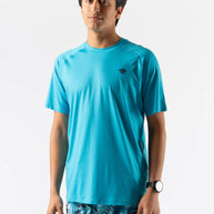 Man wearing turquoise ICE Perf Tee SS - Men by Rabbit, lightweight perforated sustainable nylon tee ideal for quick drying and active use.