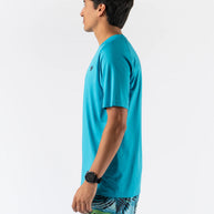 Side view of man wearing turquoise ICE Perf Tee SS - Men by Rabbit, lightweight, soft, quick-drying sustainable nylon for active use