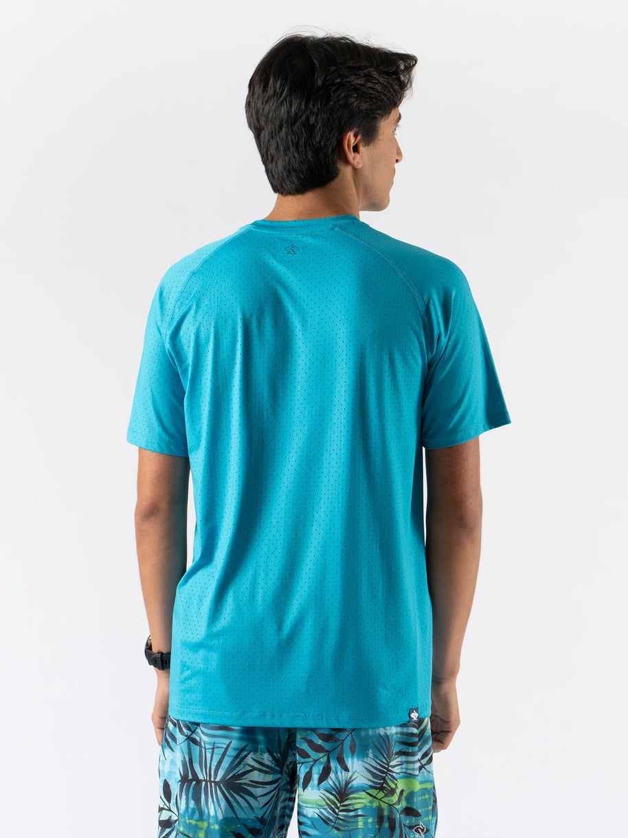 Man wearing turquoise ICE Perf Tee SS - Men by Rabbit, lightweight perforated tee made from recycled nylon for quick drying.