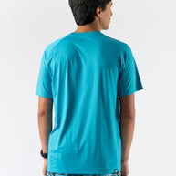 Man wearing turquoise ICE Perf Tee SS - Men by Rabbit, lightweight perforated tee made from recycled nylon for quick drying.