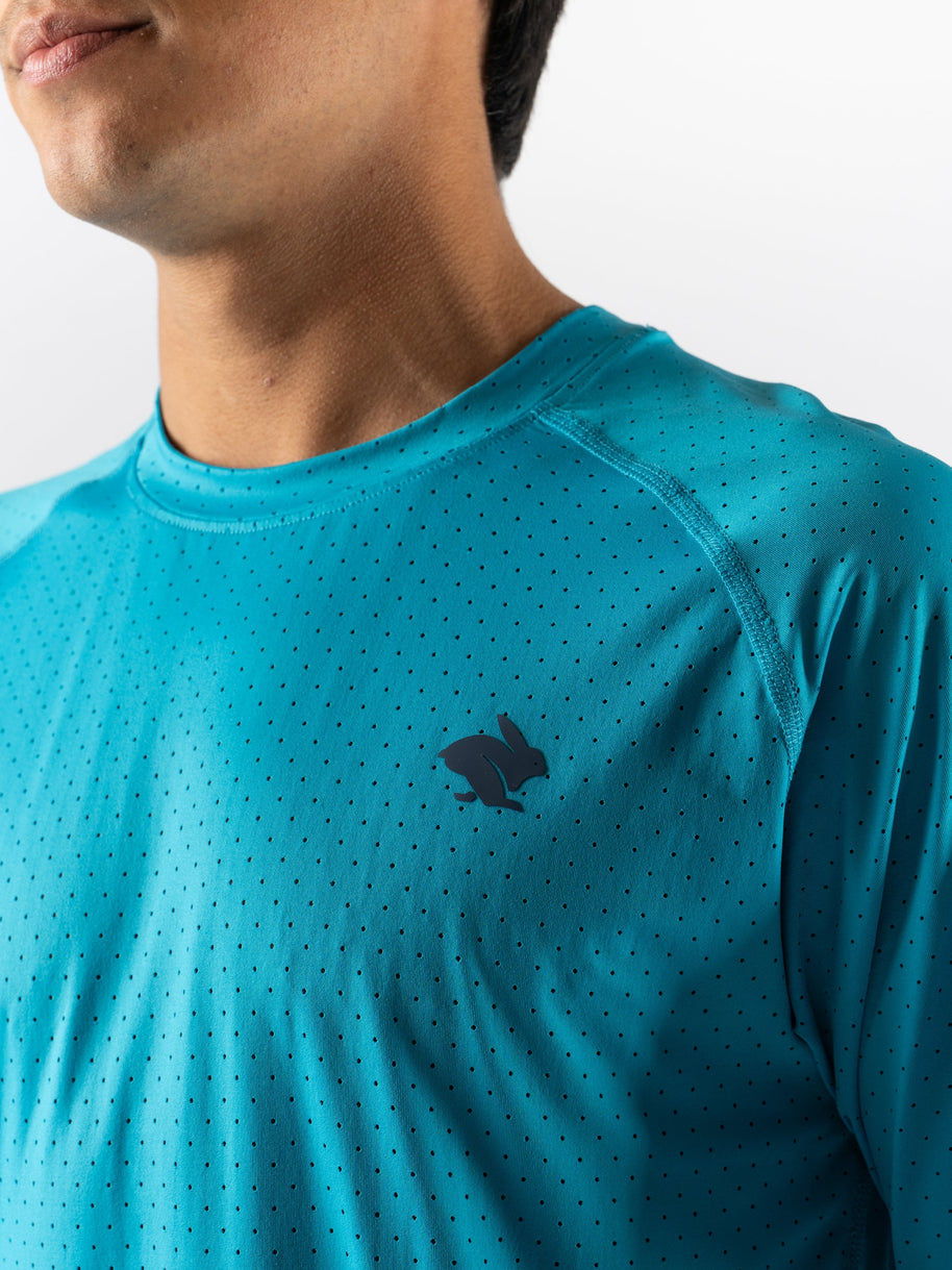 Close-up of turquoise ICE Perf Tee SS - Men by Rabbit made from sustainable lightweight nylon with all-over perforation for quick-drying comfort