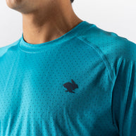 Close-up of turquoise ICE Perf Tee SS - Men by Rabbit made from sustainable lightweight nylon with all-over perforation for quick-drying comfort