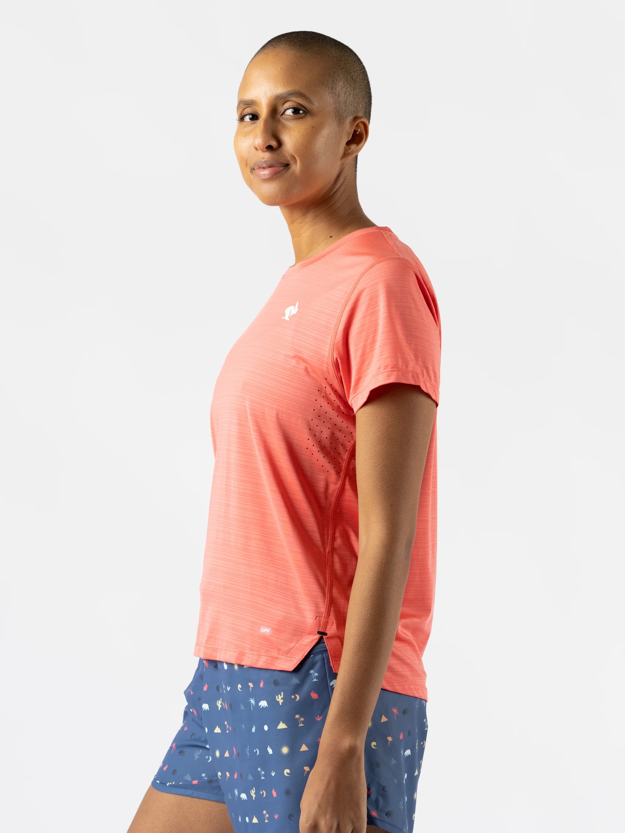 UPF Tee SS - Women by Rabbit in coral with laser-cut perfs, lightweight breathable UPF 50 shirt ideal for running and outdoor use