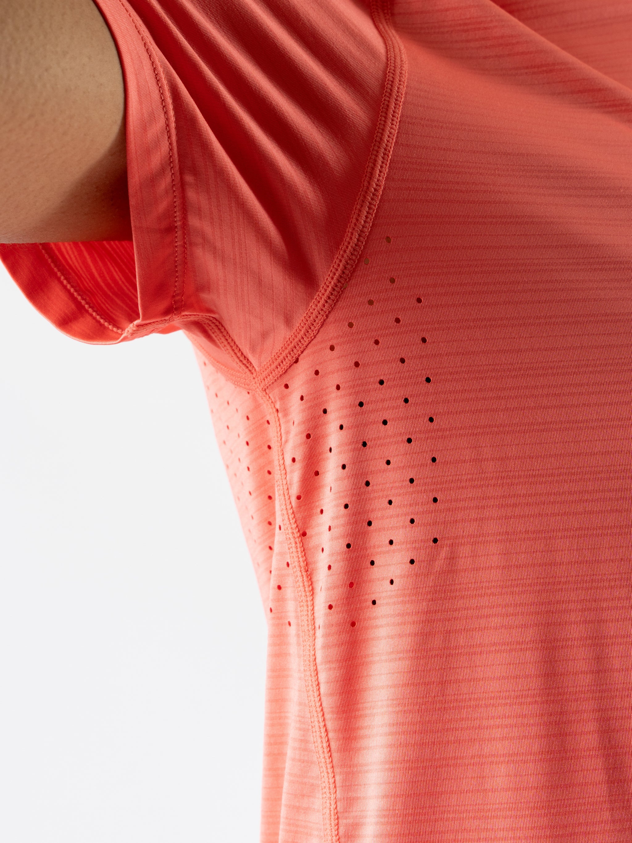 UPF Tee SS - Women by Rabbit in coral with laser-cut vented underarms, lightweight UPF 50 tee ideal for sun protection and running