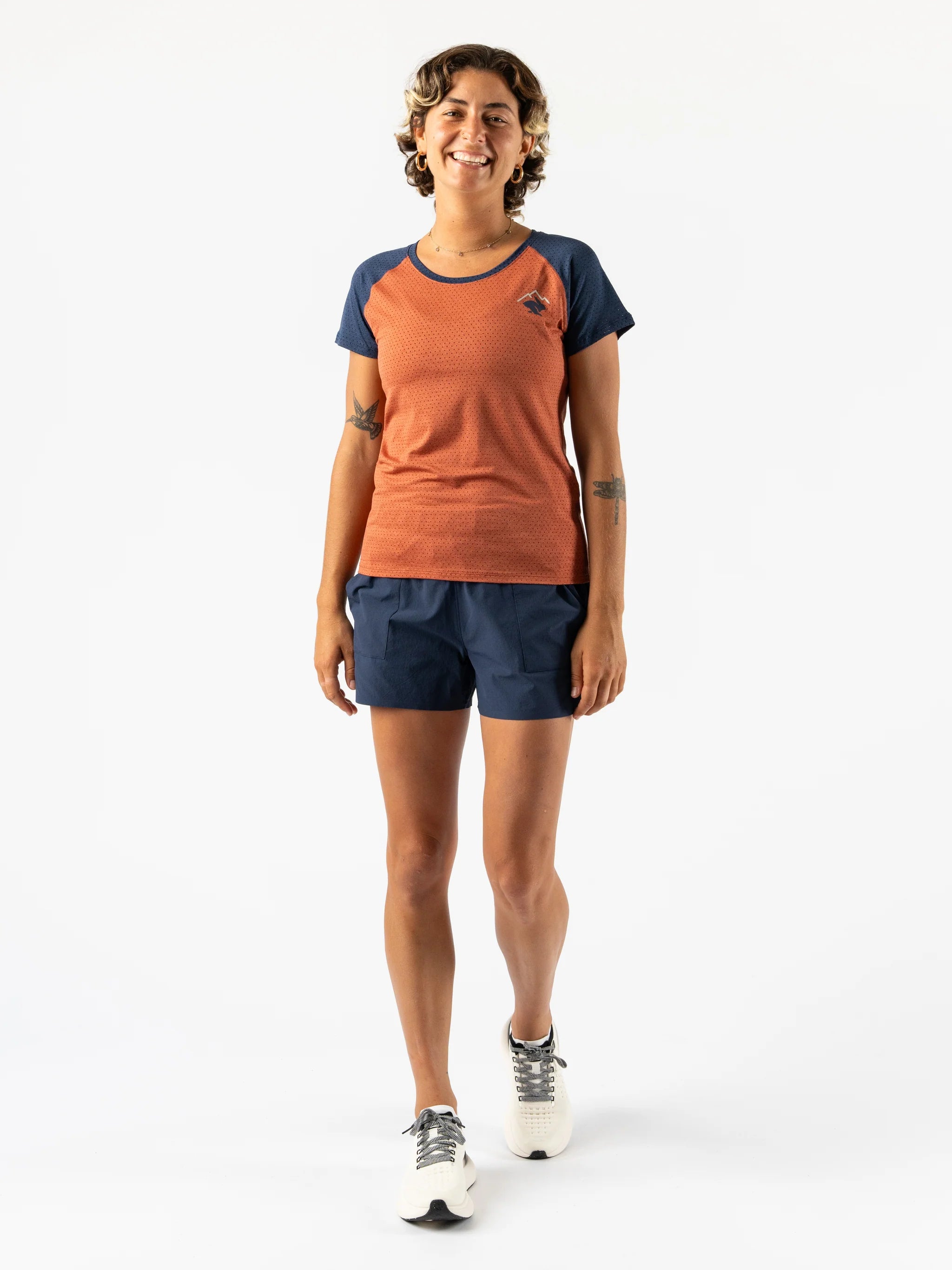 EZ Tee Perf SS Trail - Women by Rabbit in burnt orange and navy, breathable perforated running top ideal for trail running and outdoor activities
