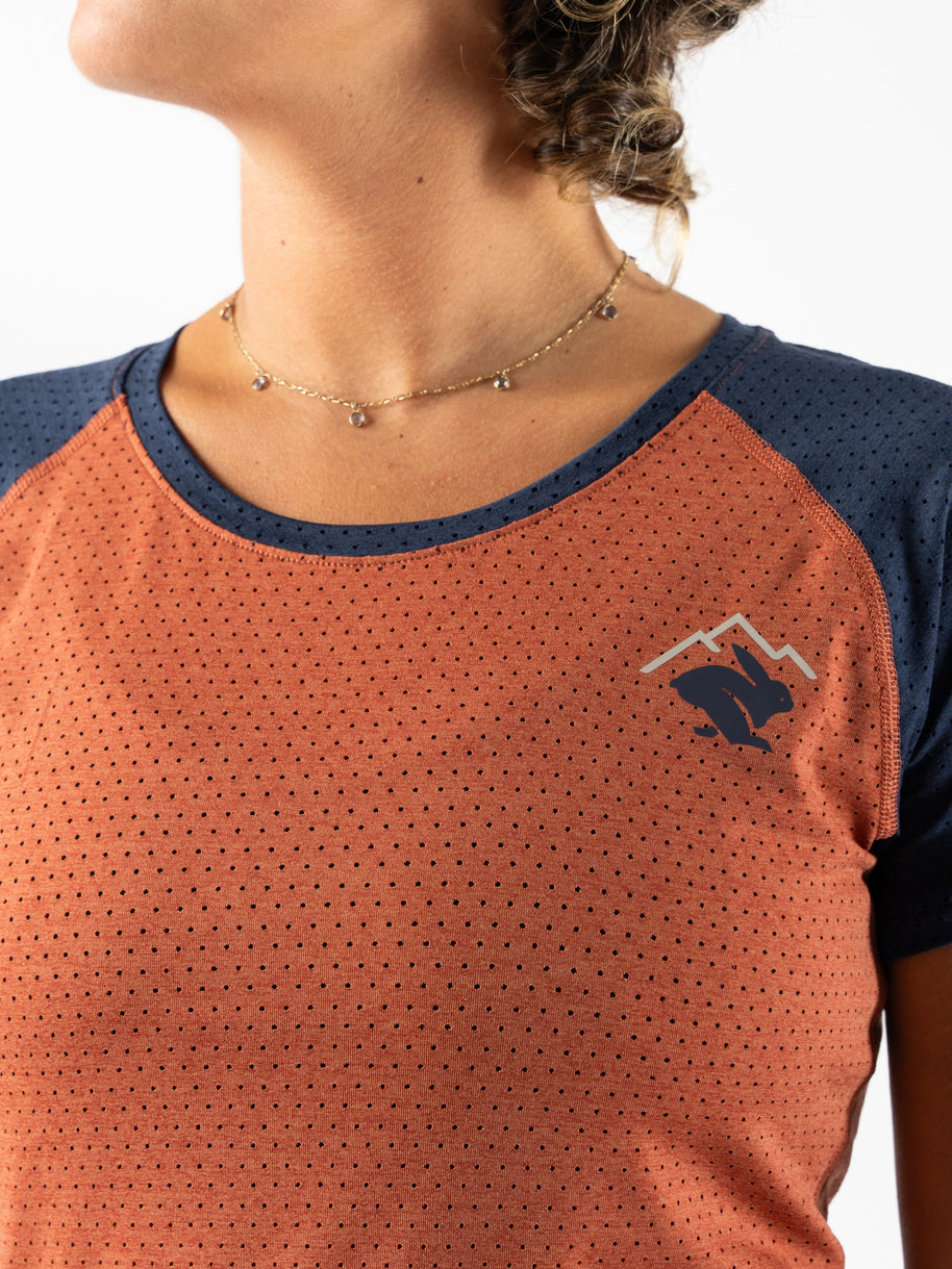EZ Tee Perf SS Trail - Women by Rabbit in rust and navy with perforations for lightweight breathability, soft trail running top ideal for outdoor use