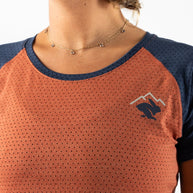 EZ Tee Perf SS Trail - Women by Rabbit in rust and navy with perforations for lightweight breathability, soft trail running top ideal for outdoor use