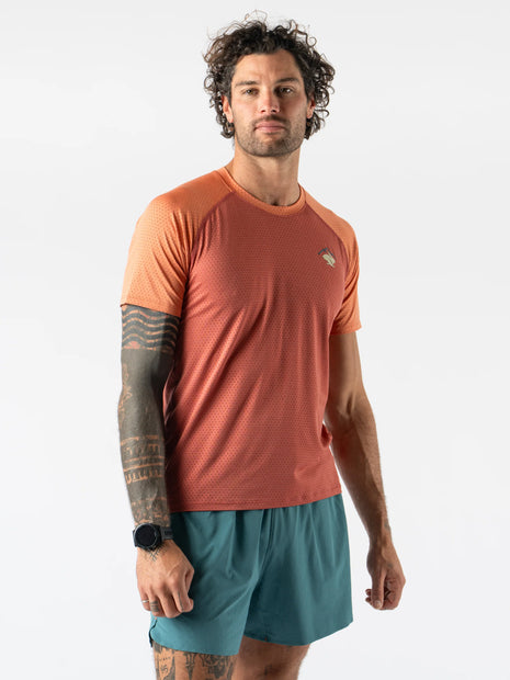 EZ Tee Perf SS Trail - Men by Rabbit in burnt orange with lightweight perforated fabric, breathable trail running shirt ideal for outdoor running.