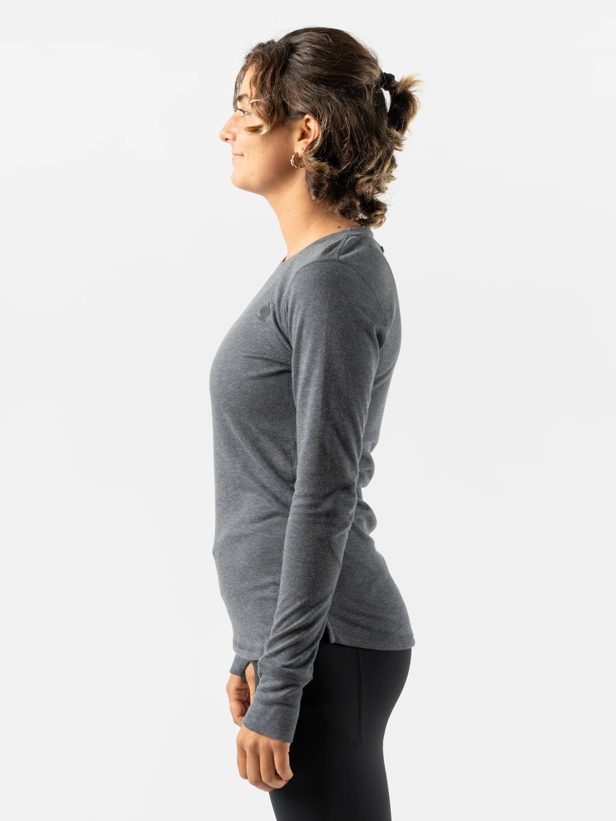 Outrun - Women by Rabbit in dark grey midweight wool knit top, odor-resistant, quick-drying base layer ideal for cold weather running