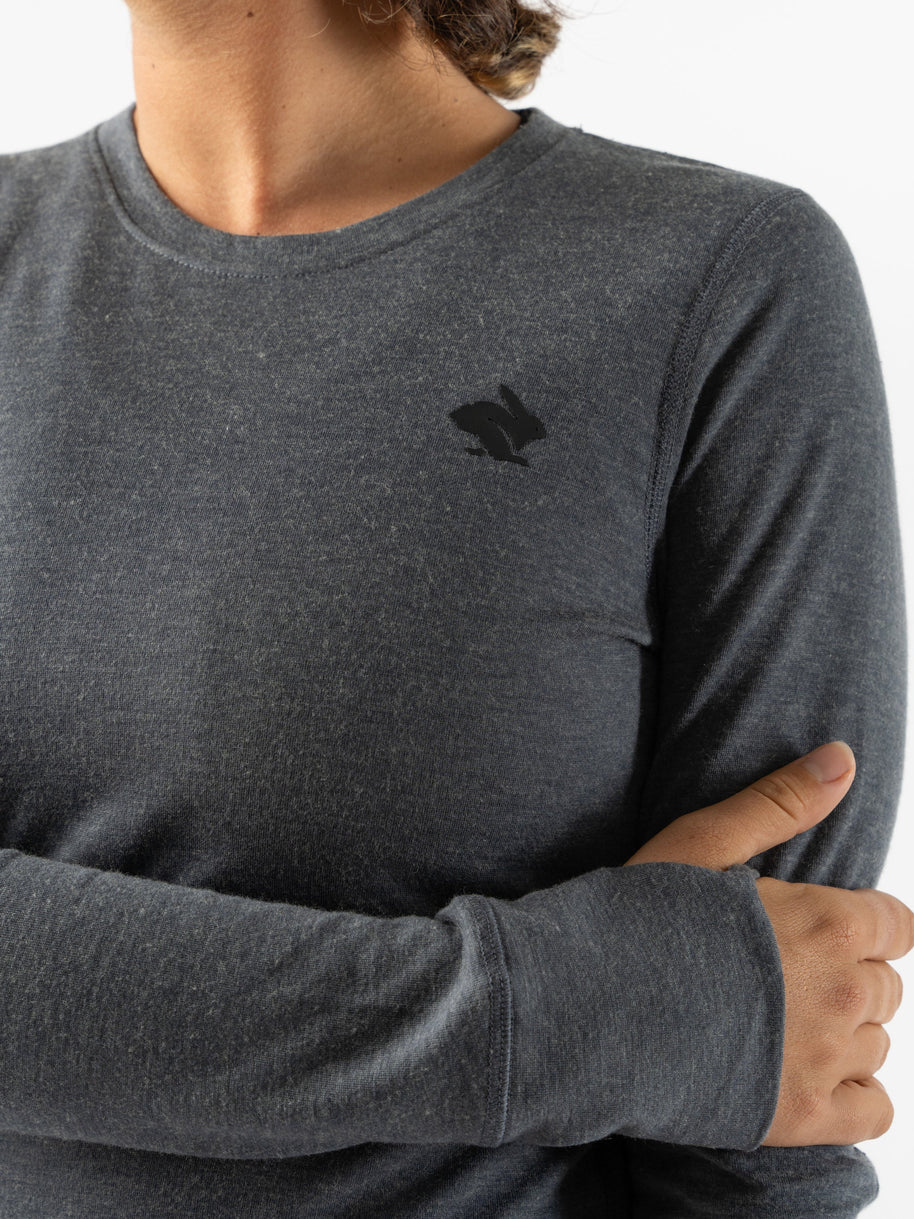 Outrun - Women by Rabbit in charcoal grey, midweight wool blend top that resists odor, dries quickly, and regulates temperature for cold weather running