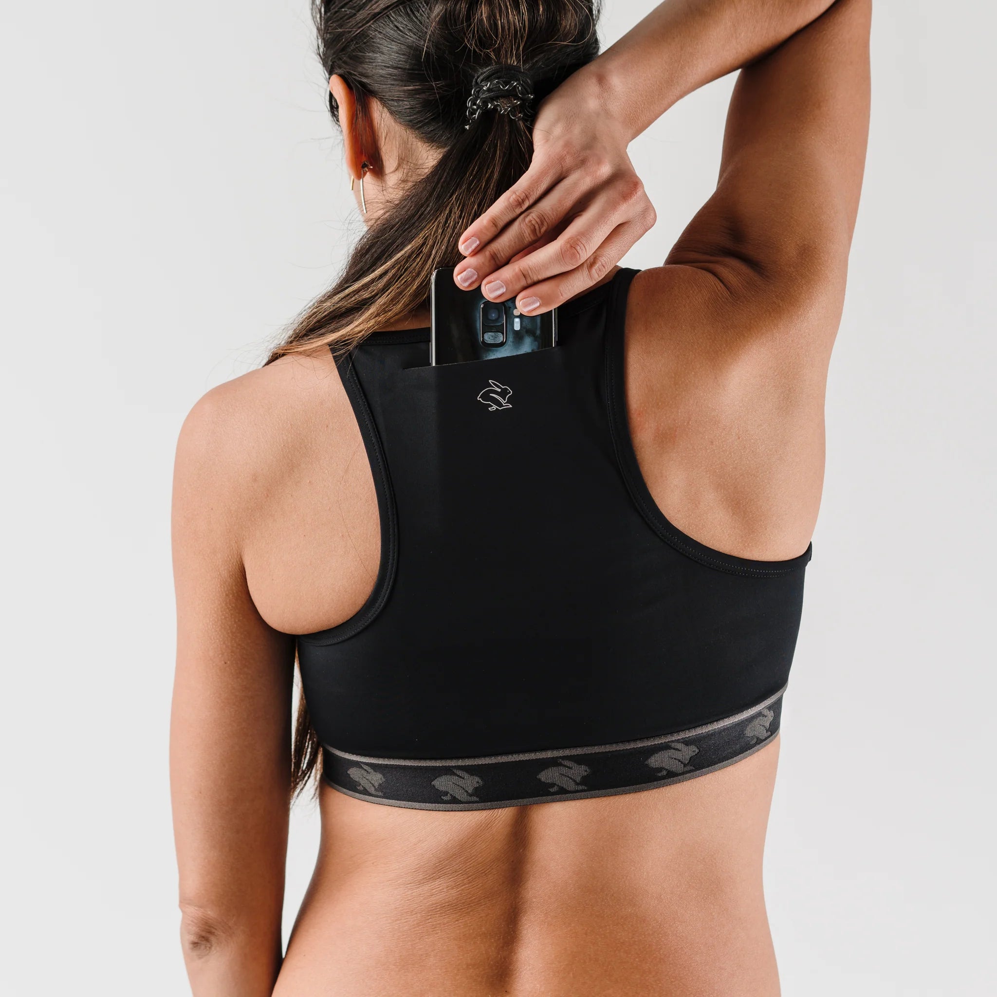 Strappy Pocket Bra - Women by Rabbit in black with built-in pocket, minimal bounce, comfortable fit, ideal for secure storage and active use