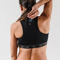 Strappy Pocket Bra - Women by Rabbit in black with built-in pocket, minimal bounce, comfortable fit, ideal for secure storage and active use