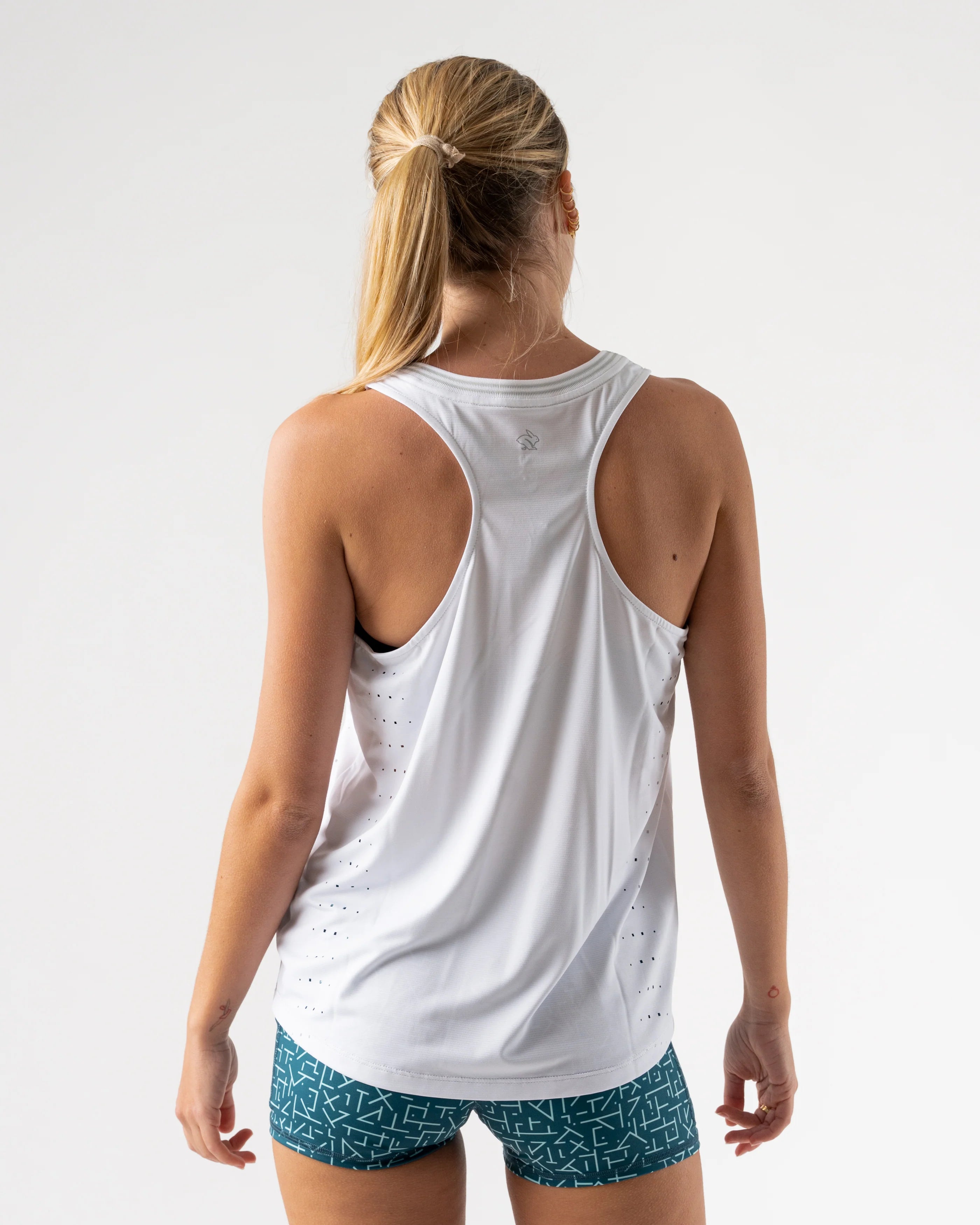 Race Pace Tank - Women by Rabbit in white with laser-cut perfs and microtextured inside for breathable comfort during running training and races