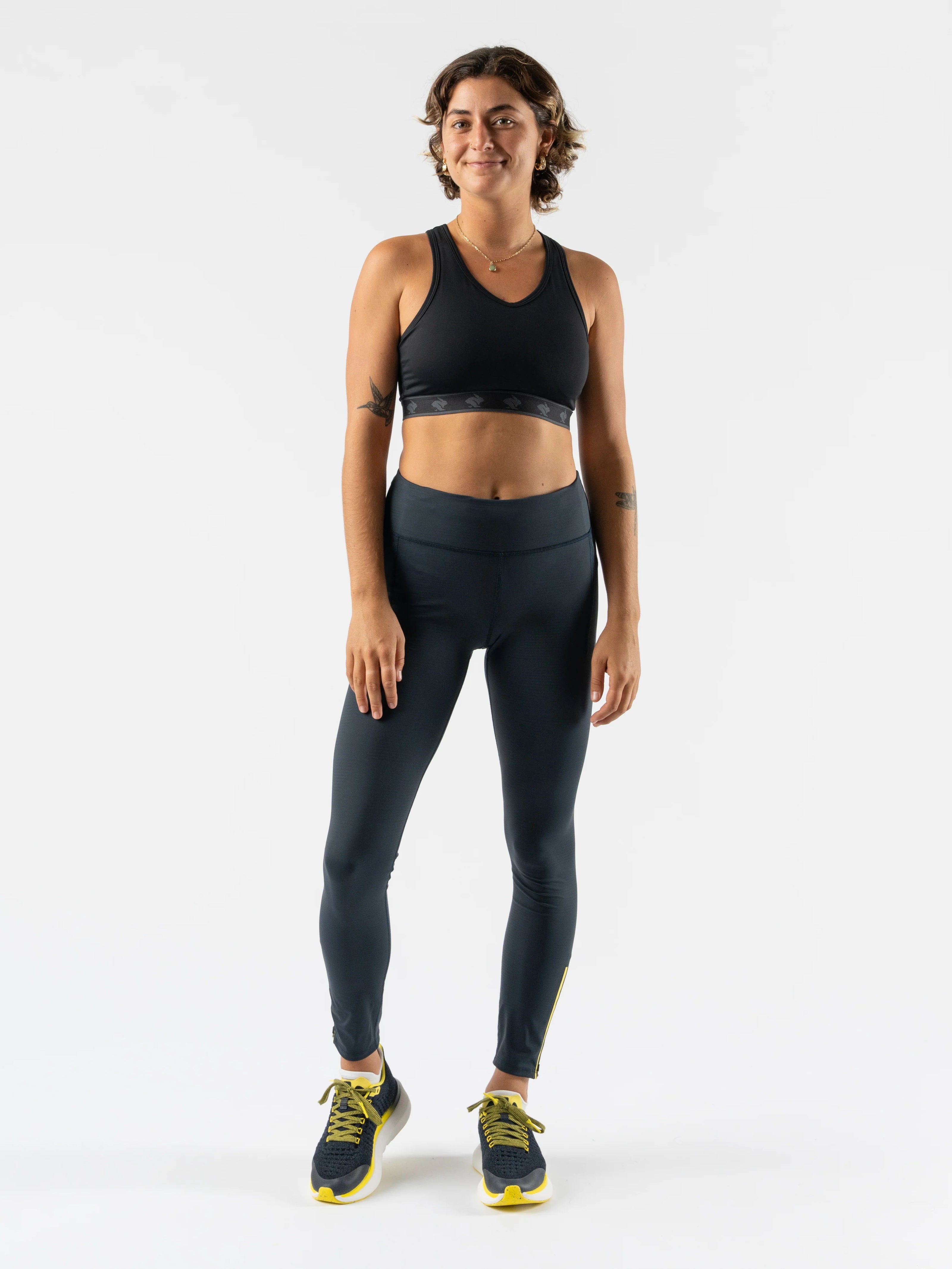Low Light Speed Tights - Women by Rabbit in dark grey with reflective print, compressive fit, laser-cut perfs, and five pockets for running