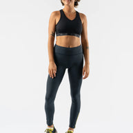 Low Light Speed Tights - Women by Rabbit in dark grey with reflective print, compressive fit, laser-cut perfs, and five pockets for running