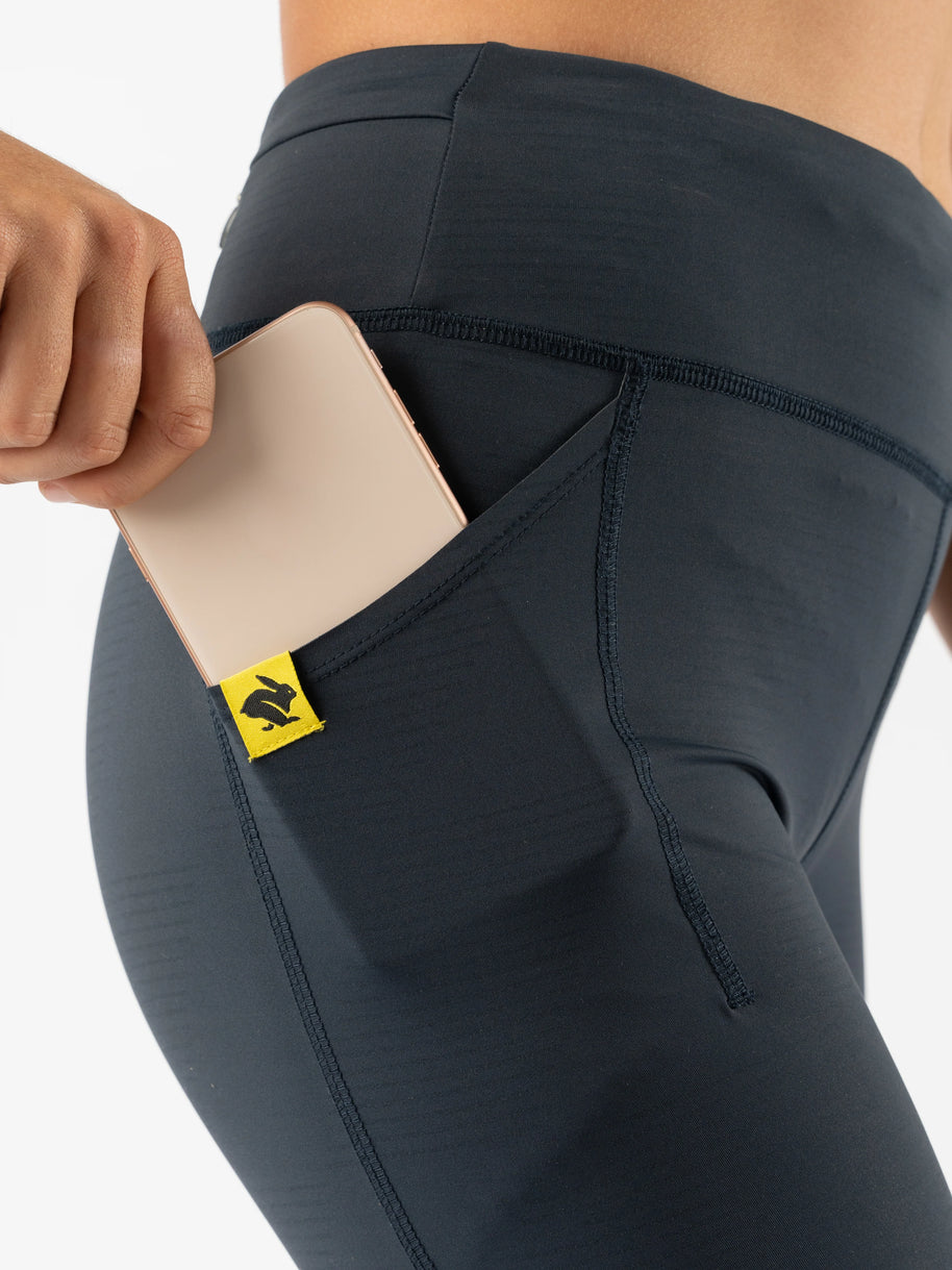 Low Light Speed Tights - Women by Rabbit in black with five pockets, compressive fit, reflective print for safe running in low light conditions