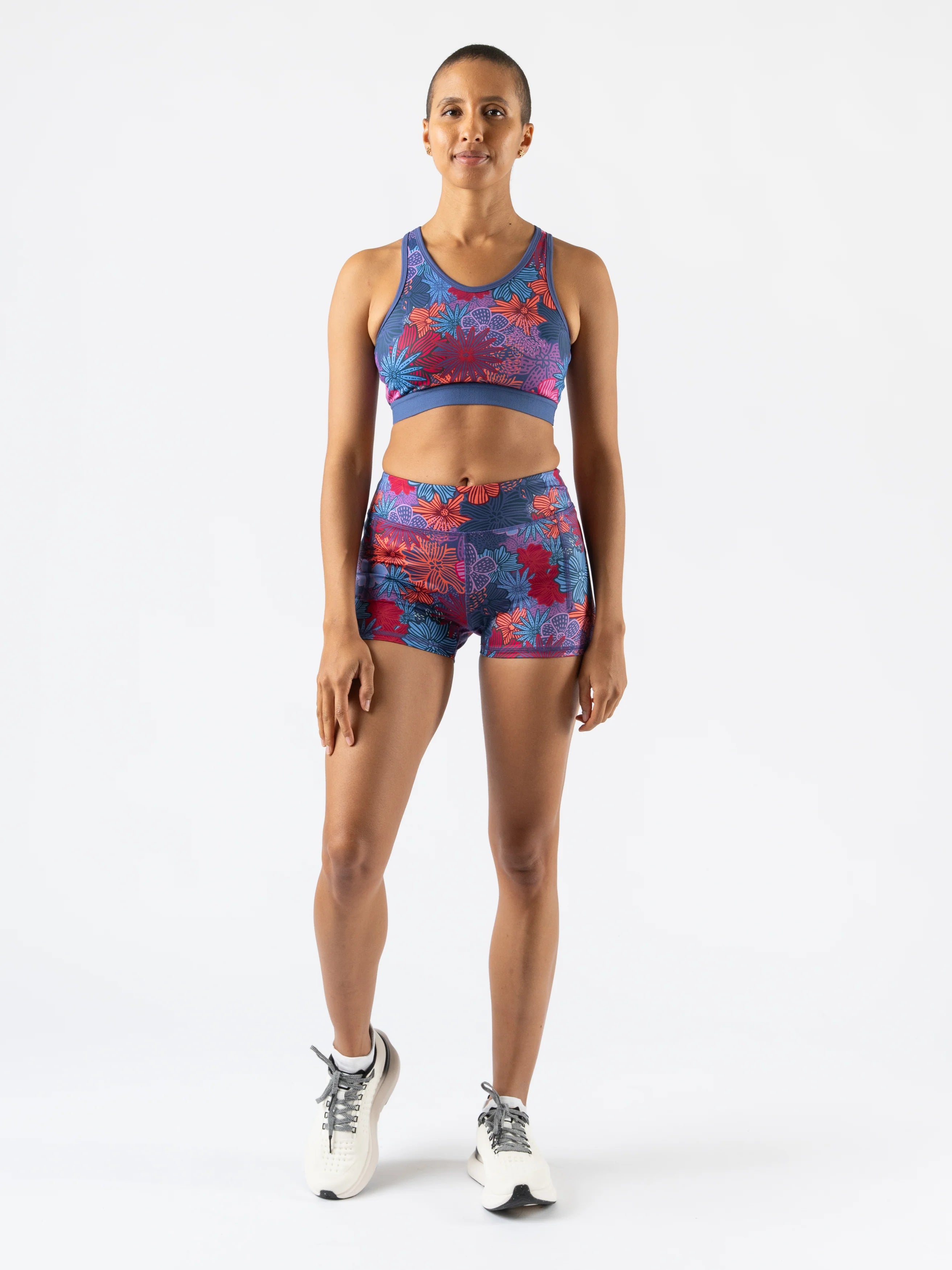 Utili Bra-Vo by Rabbit in blue and red floral pattern, multifunctional sports bra with laser-cut pocket, ideal for running and active women