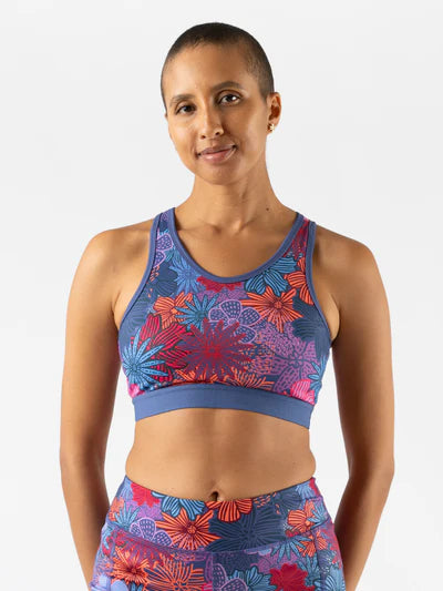 Utili Bra-Vo by Rabbit in blue and red floral pattern, multifunctional sports bra with laser-cut pocket for secure running essentials