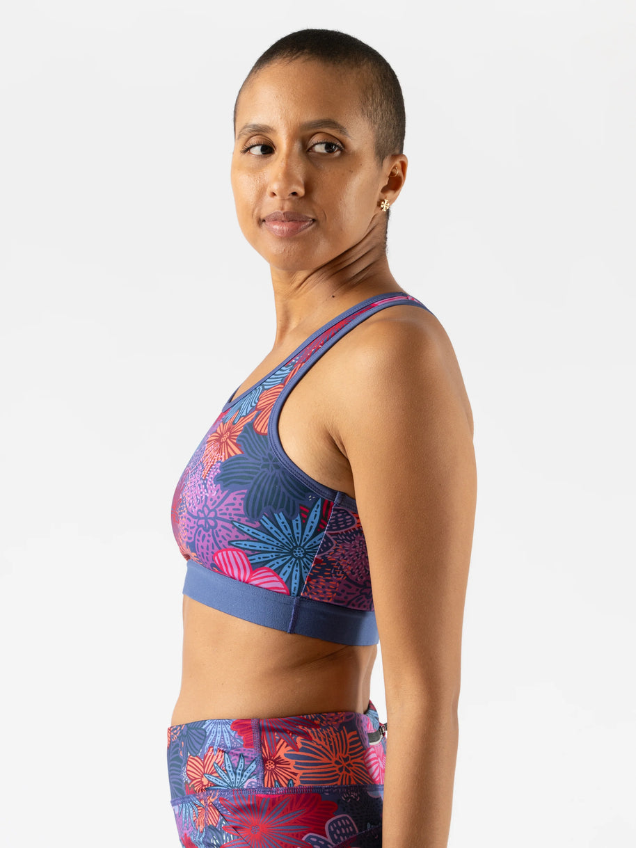 Utili Bra-Vo by Rabbit in blue and pink floral print, multifunctional sports bra with laser-cut back pocket minimizing bounce for running
