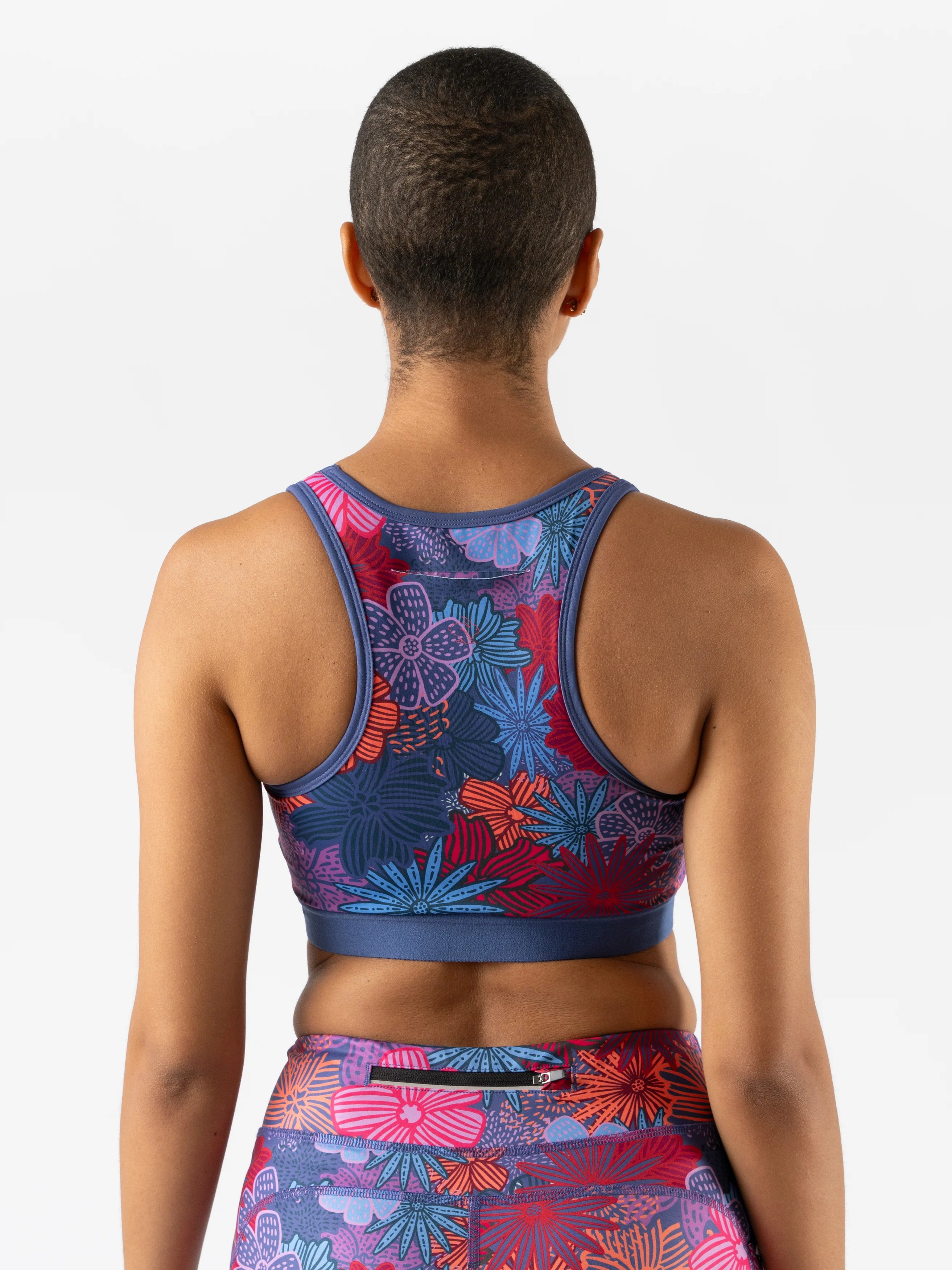 Utili Bra-Vo by Rabbit in multicolor floral design, multifunctional sports bra with laser-cut back pocket, minimizing bounce for running and training